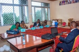 Mr. Ngifor Ronald seated with a laptop presenting his master's dissertation to a four-person evaluation panel, including Prof. Jean Pierre Atouga, at the Advanced School of Translators and Interpreters (ASTI) in Buea.