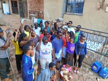 Members of Hope Social Union for the Visually impaired standing with their white canes